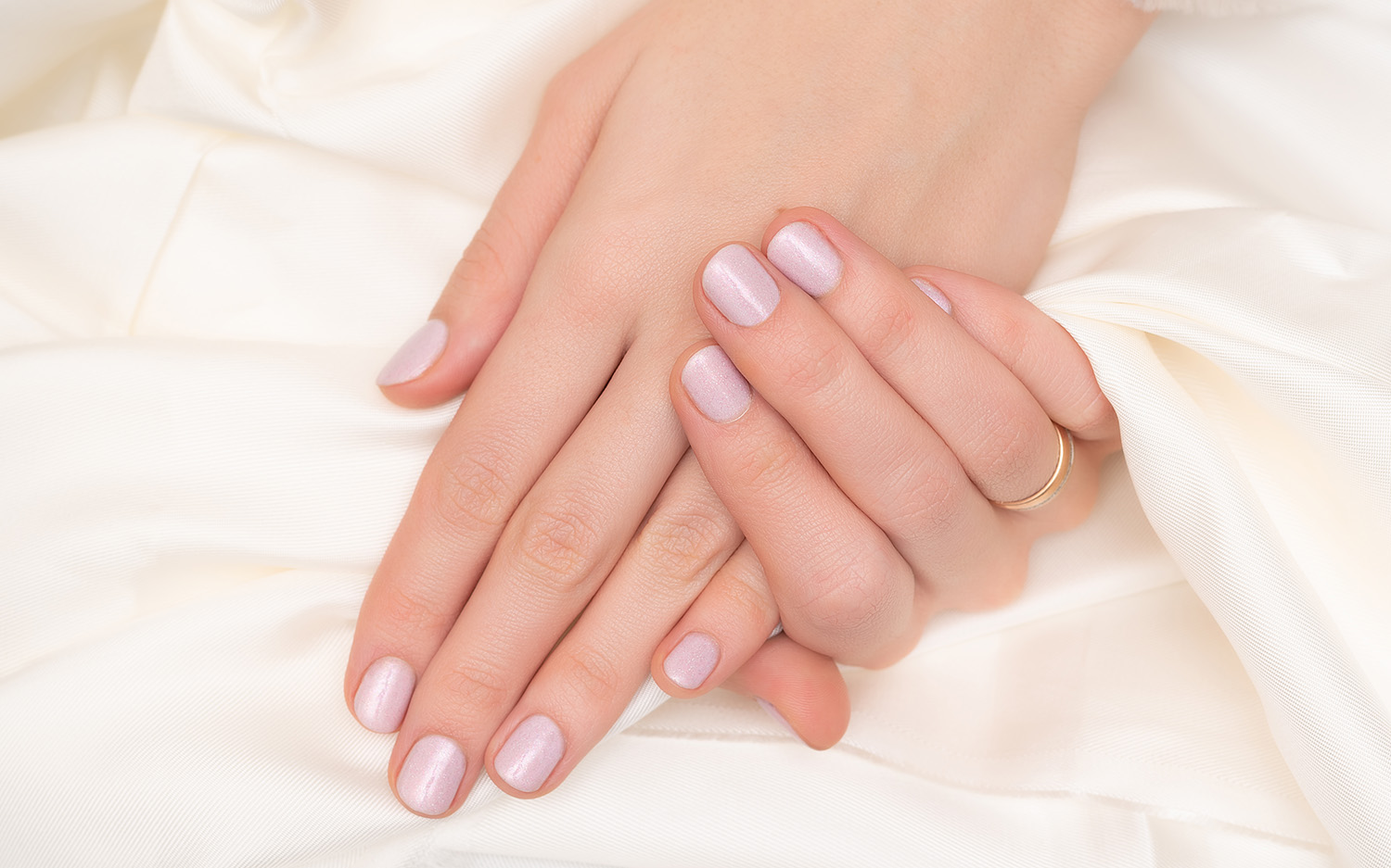 Pink nail design. Female hands with glitter manicure