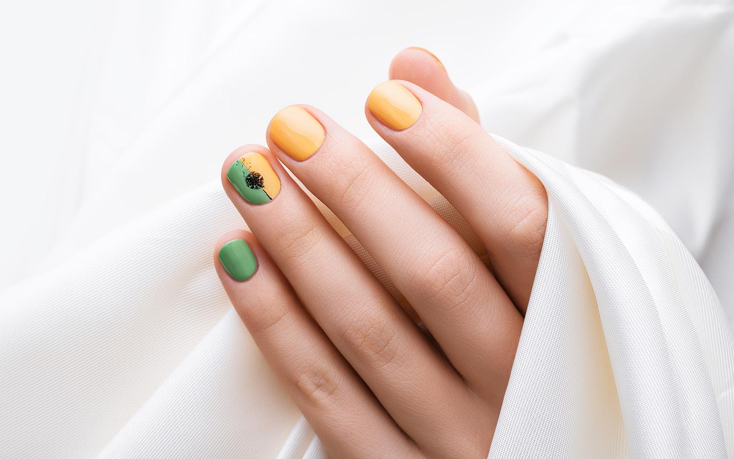 Green nail design. Female hand with color manicure